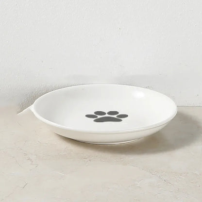 Bol blanc avec motif pattes de chat design épuré.